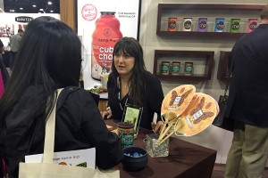 Jodet, of David Rio, discussing product with a show attendee at SCAA 2016. Credit: C. Graiff