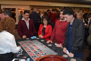 Employees enjoy casino games at the Wilsonville 2017 Holiday Party